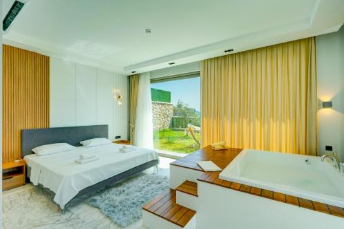 a bedroom with a bed and a bath tub at Villa Pluto 1 - PLANET LUXURY VILLAS in İslâmlar