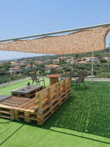 a patio with a table and chairs under a pavilion at Blue Diamond in Chrani