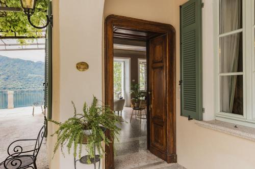 an open door of a house with a plant at Villa Antica Colonia SPA & Wellness in Pettenasco