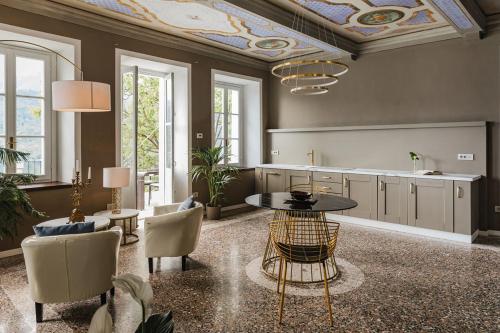 a large living room with a table and chairs at Villa Antica Colonia SPA & Wellness in Pettenasco