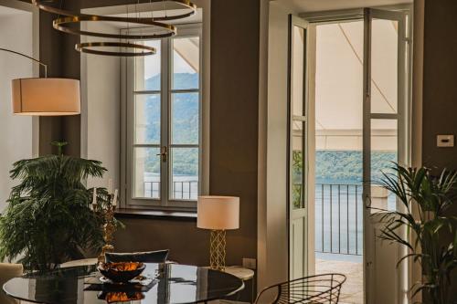 a dining room with a table and a large window at Villa Antica Colonia SPA & Wellness in Pettenasco