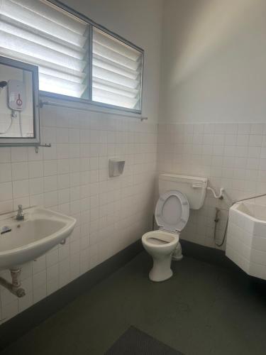 a bathroom with a toilet and a sink at Jenny Homestay in Teluk Intan