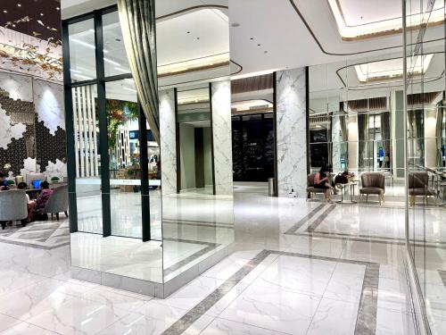 a lobby of a building with glass walls at Benson Tower Surabaya Apartment 2BR by Le Ciel Hospitality in Lontar