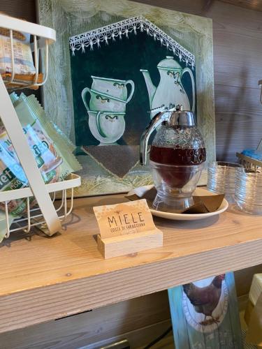 a shelf with a tea pot and a sign on it at Agriturismo Costa di Faraggiana in Levanto