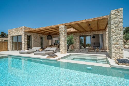 a villa with a swimming pool and a house at Lithos Art Villas in Sarlata