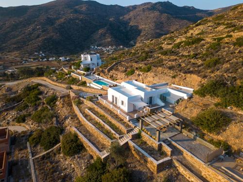 an aerial view of a white house on a hill at Sea and Sun l in Mylopotas