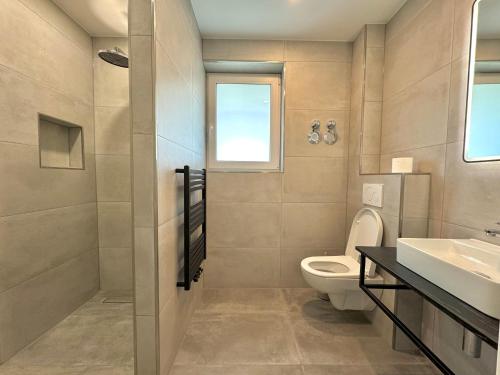 a bathroom with a toilet and a sink at Aparts House - Balkon - Free Parking- WiFi - Kitchen in Essen