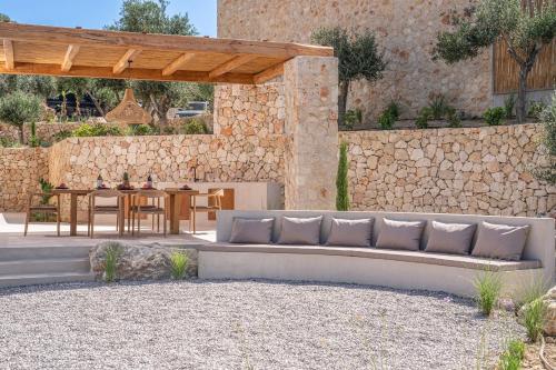 a patio with a couch and a table at Lithos Art Villas in Sarlata
