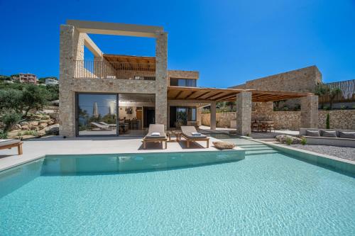 a villa with a swimming pool and a house at Lithos Art Villas in Sarlata
