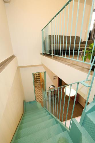 a staircase in a house with blue stairs at Dogpound Hotel in Athens