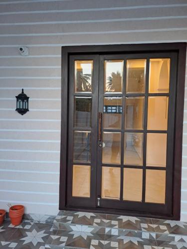 a front door of a house with a lamp at The Heritage Inn in Nāgore