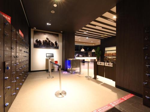 a locker room with lockers and a table in it at The Centurion Sauna Rest & Stay Sapporo Male Only in Sapporo