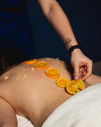 a man in a towel with oranges on his back at Focus Hotel Premium Lublin Conference & SPA in Lublin
