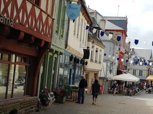 a man and a woman walking down a street at ANCRE BLEU in Hillion