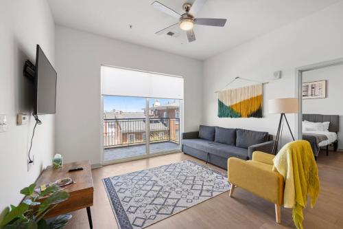 a living room with a couch and a table at Modern Nulu 2BR CozySuites 02 in Louisville