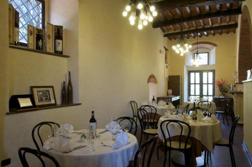
a dining room table with chairs and tables at Agriturismo Castello Di Querceto in Lucolena in Chianti
