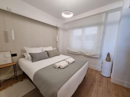 a bedroom with a large bed with two towels on it at VibesCoruña-Rubine 20 in A Coruña