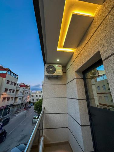 a view of a building with a balcony with a fan at VELUXA - LUXURY HOLIDAY HOMES - Centric flat in Tangier