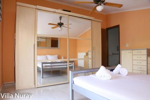 a bedroom with two beds and a mirror at Villa Nuray in Keramoti