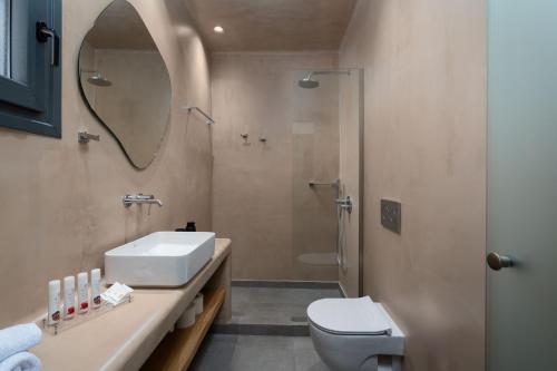 a bathroom with a sink and a toilet and a mirror at LyMaRou Collection in Megalokhori