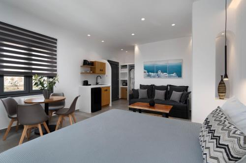 a bedroom and living room with a couch and a table at LyMaRou Collection in Megalokhori