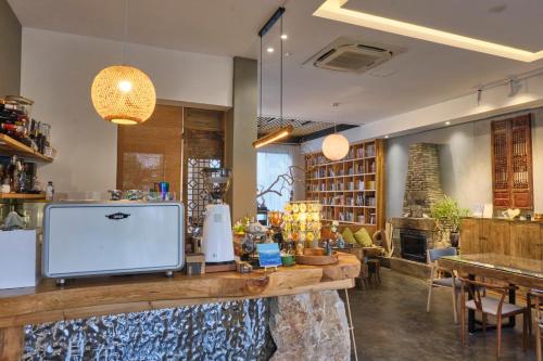 um restaurante com um balcão com uma televisão em Nature Cure Village Lodge-婺源自在舍 em Wuyuan