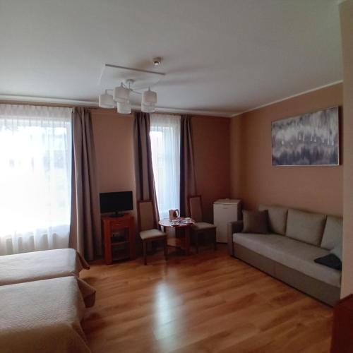 a living room with a couch and a table at Jūras Brīze in Ventspils