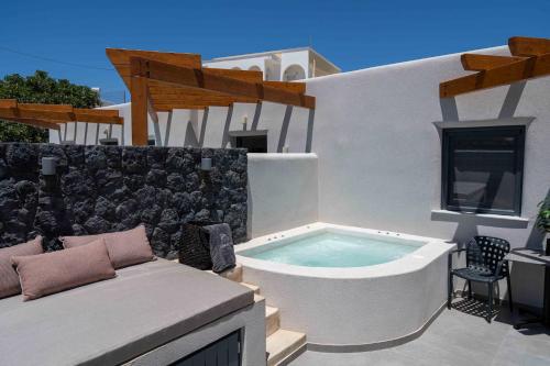 a hot tub on the patio of a house at LyMaRou Collection in Megalokhori