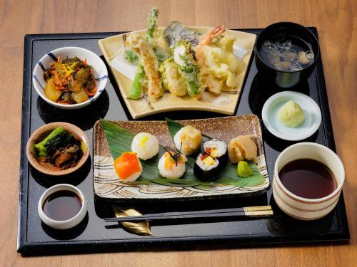 a tray with three plates of food on a table at Hakuba Tokyu Hotel in Hakuba