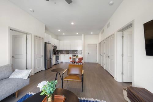 a living room with a couch and a table at Modern Nulu 2BR CozySuites 06 in Louisville