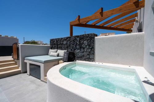 a hot tub on thevisor of a house with a patio at LyMaRou Collection in Megalokhori