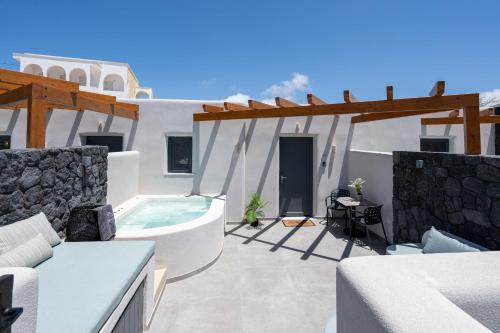 a villa with a hot tub on a patio at LyMaRou Collection in Megalokhori