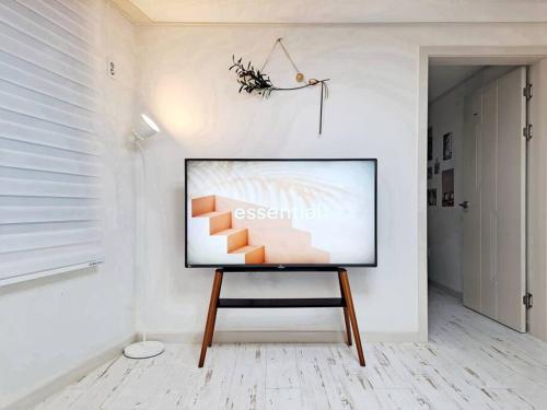 a flat screen tv sitting on a stand in a room at HaengGung MaSil in Suwon