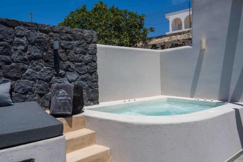 a hot tub in the corner of a building at LyMaRou Collection in Megalokhori