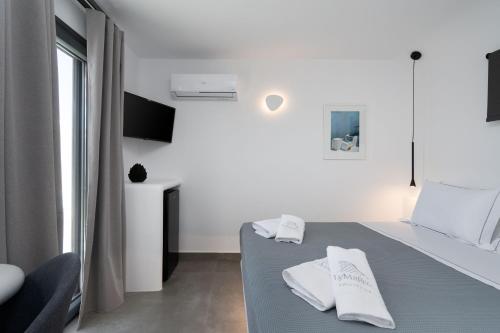 a white room with a table with two white towels at LyMaRou Collection in Megalokhori
