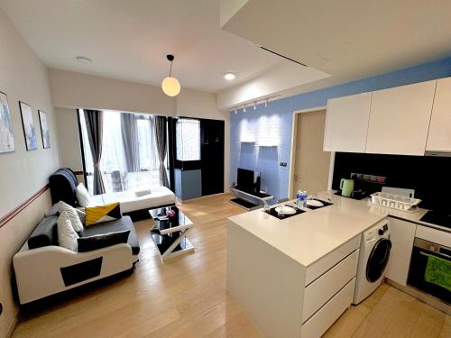 a kitchen and living room with a couch and a table at Star Residence Suite KLCC in Kuala Lumpur