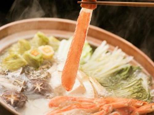 a bowl of soup with a carrot and vegetables at Tsuruya Ryokan in Toyooka