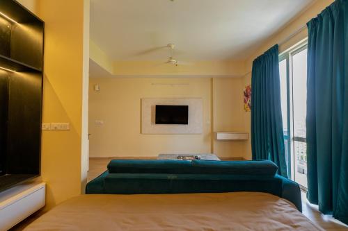 a bedroom with two beds and a tv at Skystay Lucknow in Lucknow