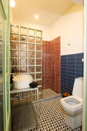 a bathroom with a sink and a toilet in it at Dogpound Hotel in Athens