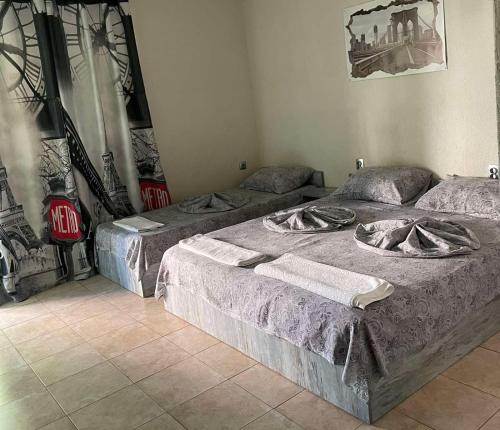a room with three beds in a room at Комплекс Дворъ in Varna City