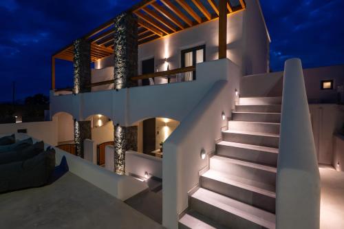 a staircase leading up to a house at night at LyMaRou Collection in Megalokhori