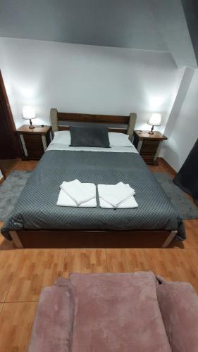 a bedroom with a bed with two pillows on it at Ferradosa GuestHouse in São João da Pesqueira