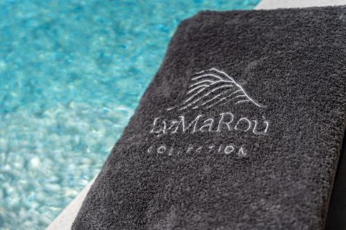 a book sitting next to a swimming pool at LyMaRou Collection in Megalokhori