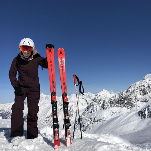 a person standing on top of a snow covered mountain with skis at Alpenhotel Tirolerhof in Neustift im Stubaital
