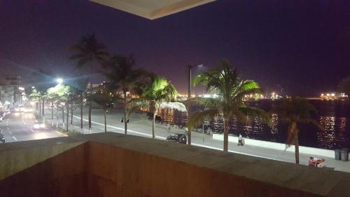 a city at night with palm trees and a street at Hotel Royalty in Veracruz
