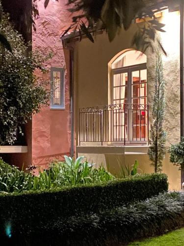 a house with a window and plants in front of it at Guestlands Italia B&B in Arcadia
