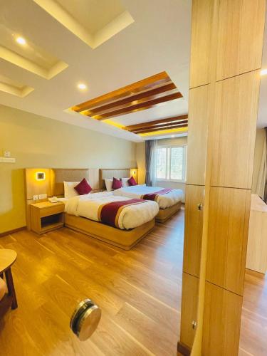 a bedroom with two beds in a room at Hotel Aerocity in Kathmandu