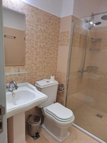 a bathroom with a toilet and a shower and a sink at Bogdanov in Lozenets