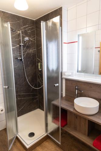 a bathroom with a shower with a toilet and a sink at Landgasthof & Brauerei Löwen Sasbach in Sasbach in der Ortenau