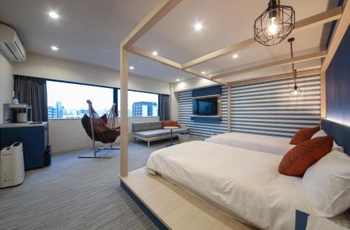 a bedroom with a bed and a living room at Spa World HOTEL&RESORT in Osaka